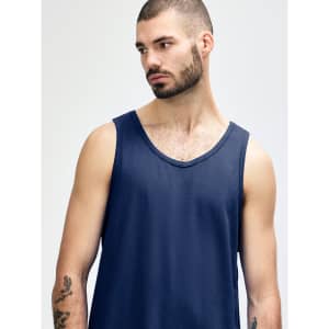 A navy blue Gildan Heavy Cotton adult tank top on a model, featuring a logo.