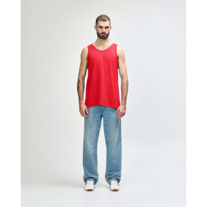 A red Gildan Heavy Cotton adult tank top displayed on a model, paired with black pants and shoes.
