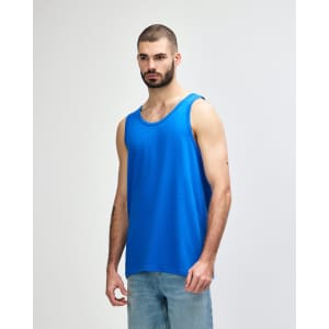 A blue Gildan Heavy Cotton adult tank top displayed on a model, featuring a classic sleeveless design and a logo.