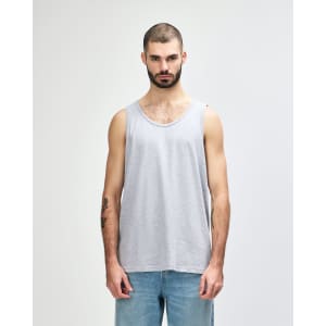 A grey adult tank top with a round neckline and a logo on the front, styled on a male model.