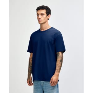 A navy blue unisex short sleeve t-shirt on a model, featuring a relaxed fit and subtle branding.