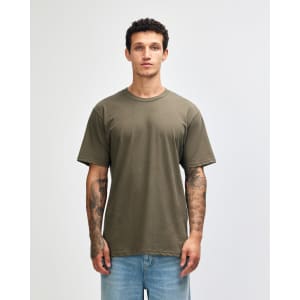 A green unisex short sleeve t-shirt with a relaxed fit and a logo on the front.