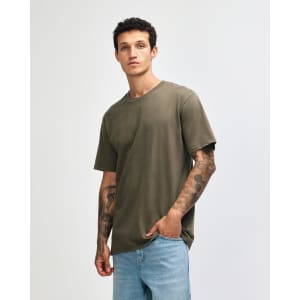 A green unisex short sleeve T-shirt displayed on a model, featuring a simple design and relaxed fit.