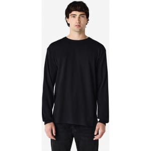 A black long sleeve t-shirt featured on a model, showcasing a simple design and a brand logo.