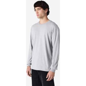 A light grey long sleeve t-shirt worn by a male model, featuring a simple design and a logo.