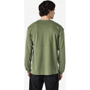 A long sleeve t-shirt in olive green, featuring a simple design with a logo on the back.