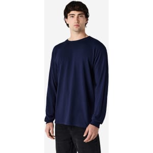 A navy long sleeve T-shirt on a male model. The shirt features a simple design and has a logo.
