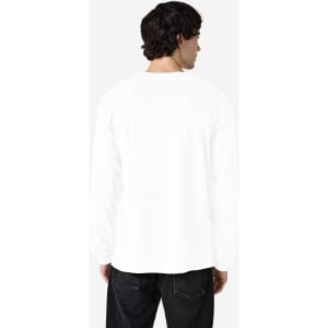 A white long sleeve t-shirt with a logo on the back, displayed on a person facing away.