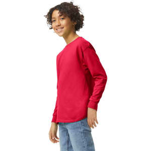 A youth long sleeve t-shirt in bright red, featuring a logo, displayed on a young person smiling.