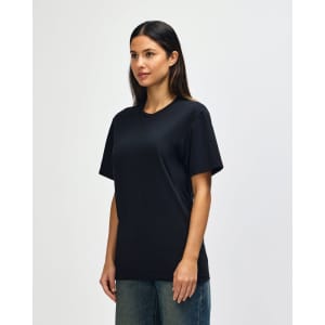 A black Gildan Softstyle adult t-shirt displayed on a model, featuring a simple design and short sleeves.