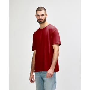 A red Gildan Softstyle adult t-shirt displayed on a model, featuring short sleeves and a relaxed fit.