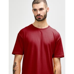 A red Gildan Softstyle adult t-shirt worn by a model, featuring a crew neckline and short sleeves.