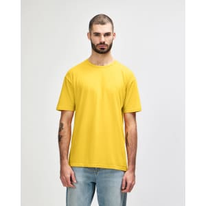 A yellow Gildan Softstyle adult t-shirt displayed on a model, featuring a logo on the shirt.
