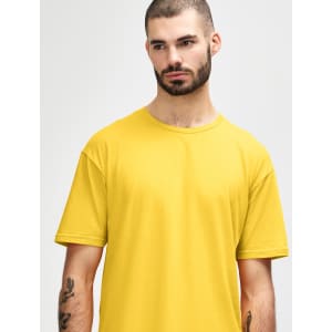 A man wearing a bright yellow Gildan Softstyle adult T-shirt, featuring a round neckline and short sleeves.