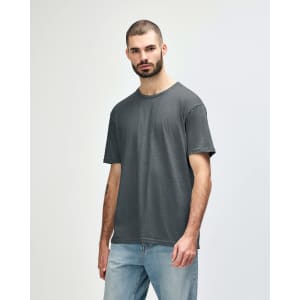 A grey Gildan Softstyle adult T-shirt displayed on a model, featuring a simple design and a relaxed fit.