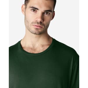 A green Gildan Softstyle adult T-shirt featuring a round neckline, modelled by a man.