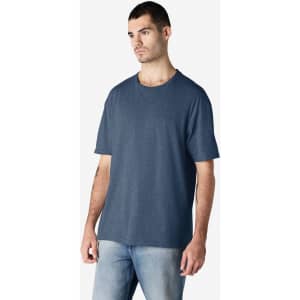 A navy adult T-shirt displayed on a male model, featuring a crew neck and short sleeves. The shirt has a logo.