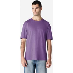 A purple Gildan Softstyle adult T-shirt displayed on a male model, featuring a casual fit and a logo.