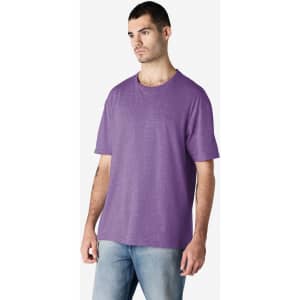 A purple Gildan Softstyle adult T-shirt displayed on a male model, featuring a relaxed fit and basic design.