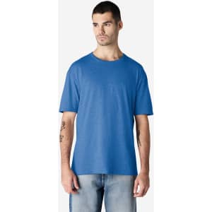 A model wearing a blue Gildan Softstyle adult T-shirt, paired with light denim jeans.