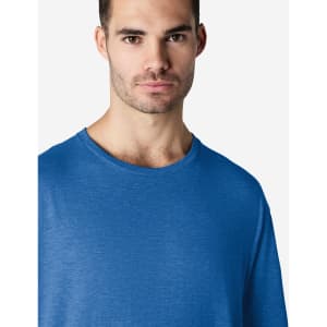 A blue Gildan Softstyle adult T-shirt displayed on a male model with a neutral expression.
