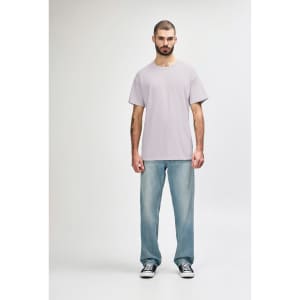 A light grey Gildan Softstyle adult t-shirt worn with blue jeans, featuring a logo on the t-shirt.
