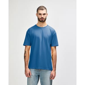 A blue Gildan Softstyle adult T-shirt displayed on a male model, featuring a basic crew neck and short sleeves.