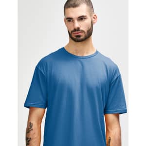 A man wears a Gildan Softstyle adult t-shirt in a deep blue colour, featuring a round neckline and short sleeves.