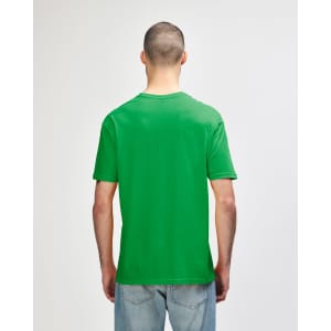 A green Gildan Softstyle adult t-shirt viewed from the back, featuring a casual fit and short sleeves.