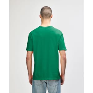 A green Gildan Softstyle adult T-shirt displayed on a person from the back, featuring a plain design.