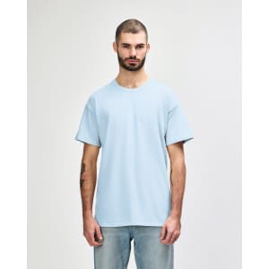 A light blue adult T-shirt displayed on a male model with short sleeves. The shirt features a logo.