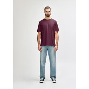 A maroon adult T-shirt displayed on a mannequin, paired with light blue jeans and white shoes. The T-shirt has a logo.