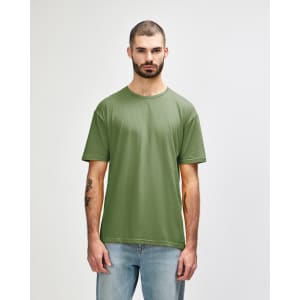 A green Gildan Softstyle adult t-shirt displayed on a male model. The t-shirt has a round neckline and short sleeves.