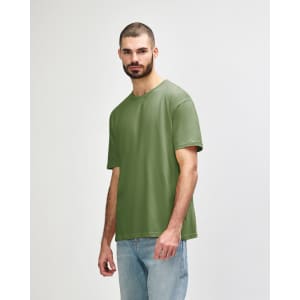 An olive green Gildan Softstyle adult t-shirt worn by a male model, featuring a simple design and a logo.