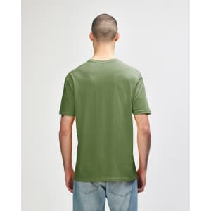 A green Gildan Softstyle adult T-shirt viewed from the back, featuring a simple design and a relaxed fit.