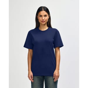 A man wearing a navy Gildan Softstyle adult t-shirt with a relaxed fit, standing against a plain background.