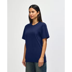 A navy blue Gildan Softstyle adult t-shirt displayed on a model, featuring a simple design and a logo.