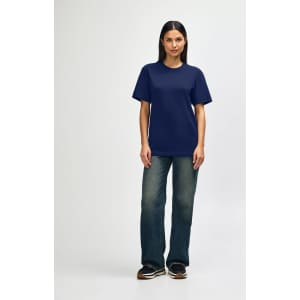 A navy Gildan Softstyle adult T-shirt displayed on a male model, paired with light blue jeans and white shoes.