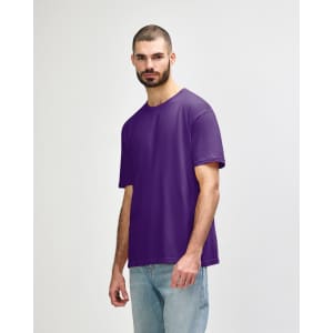 A purple Gildan Softstyle adult T-shirt displayed on a male model, with a simple design and a logo on the side.