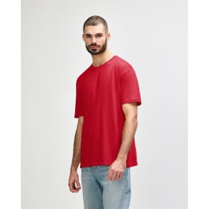 A red Gildan Softstyle adult T-shirt is displayed on a model wearing blue jeans. The shirt features a logo.