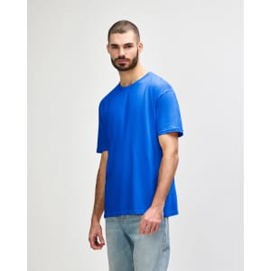 A blue Gildan Softstyle adult T-shirt displayed on a model, featuring a basic crew neck design and short sleeves.