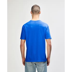 A blue Gildan Softstyle adult T-shirt viewed from the back, featuring a plain design and a tag.