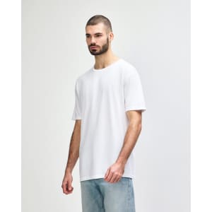 A white Gildan Softstyle adult t-shirt displayed on a model, with a simple design and soft fabric texture.