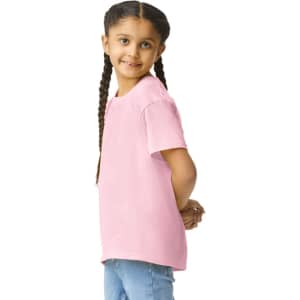 A pink Gildan Youth Softstyle short sleeve T-shirt displayed on a young girl, who has braided hair and is smiling.