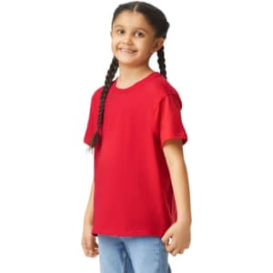 A red youth short sleeve T-shirt is displayed on a smiling child with braided hair. The shirt has a logo.