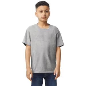 A grey Gildan Youth Softstyle short sleeve T-shirt displayed on a model standing with hands at sides.
