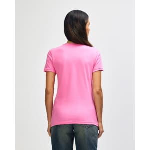 A pink Gildan Softstyle ladies' T-shirt is displayed from the back, featuring a fitted design and short sleeves.