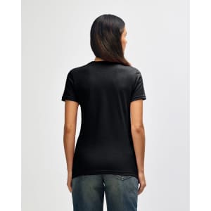 A black Gildan Softstyle ladies' T-shirt displayed on a model from the back, featuring short sleeves and a relaxed fit.