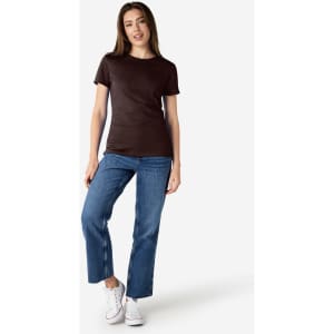 A brown Gildan Softstyle ladies' t-shirt paired with blue jeans and white sneakers, featuring a small logo.
