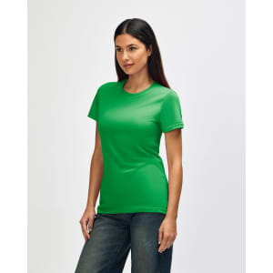 A green Gildan Softstyle ladies' T-shirt displayed on a model from the side, paired with jeans.
